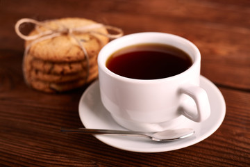 Coffee and Homemade cookies with chocolate. Handmade Chocolate cookies and cup of espresso on wooden table. Pile of delicious chip cookies. Christmas cookies. Biscuits. Oat biscuits.