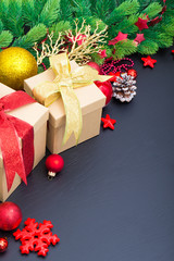 Fototapeta na wymiar Christmas gift box. Christmas presents in red boxes at black woo