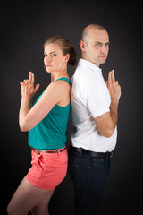 Beautiful couple doing different expressions in different sets of clothes: gun sign
