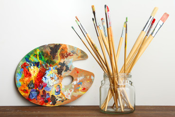 Naklejka premium Wooden art palette and brush on the table.