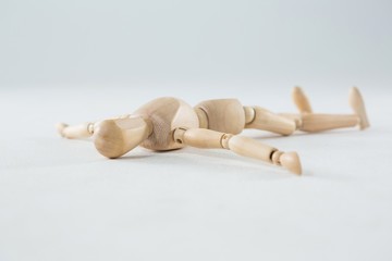 Wooden figurine lying on floor