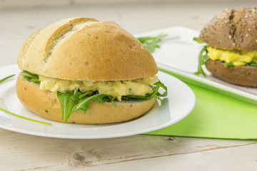 White and brown sandwiches with salads
