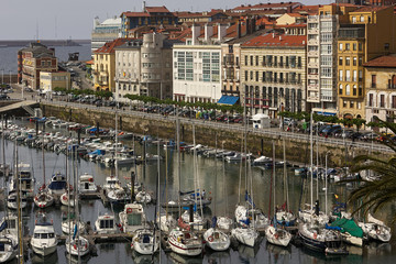 Yachts and pier in leisure port on maritime fishing district of Gijon, Spain, Europe.