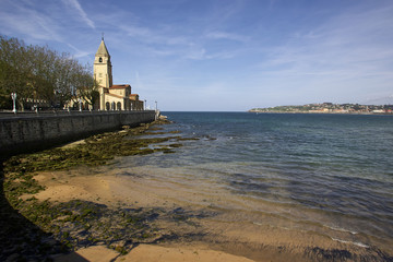 landscape of Gijon beach and San Pedro church,  travel destination in north of Spain, Europe