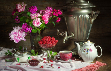 Tea Party with samovar, raspberry and jam in rustic style