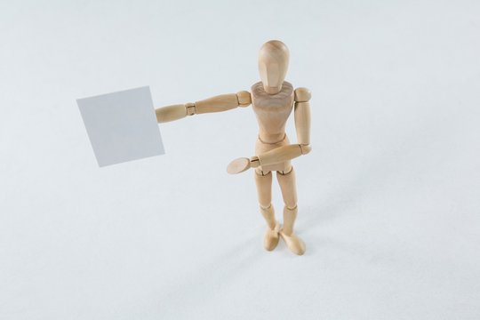 Wooden figurine showing blank placard