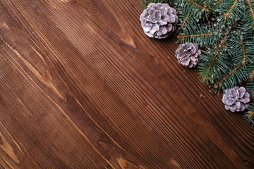Christmas background with xmas tree and sparkle bokeh lights on wooden canvas background. Merry christmas card. Winter holiday theme. Happy New Year. Space for text. Happy Holidays