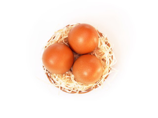 Three eggs in a nest on a white background, Easter background