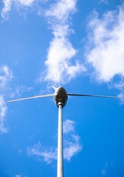 View from below of a windmill for electric power production. Outdoors.