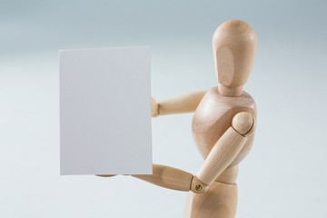 Wooden figurine showing blank placard