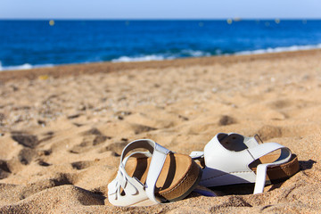 Men summer shoes on hot sand on Mediterranean beach. White men's sandals.
