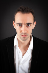 Obraz premium Handsome man doing different expressions in different sets of clothes: angry