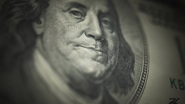 Hundred Dollar Bill, Franklin (24fps). Camera moves down the portrait of Benjamin Franklin on an uncut crisp sheet of U.S. $100 bills, freshly minted from a printing press.