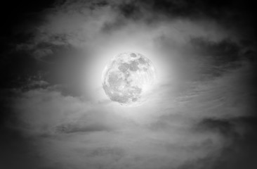 Nighttime sky with clouds and bright full moon.  Black and white