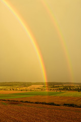 Double Rainbow over Field Landscape after Thunderstorm