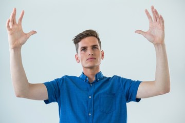 Fototapeta premium Man in blue shirt with arms raised