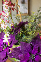 Bouquet with purple flowers on the background of the painting on the wall