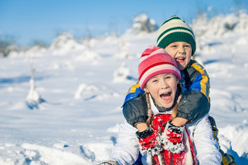 Happy little children playing  in winter snow day.