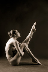 naked girl posing in studio sepia