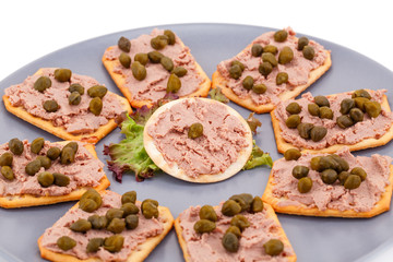 Meat pate with capers on crackers