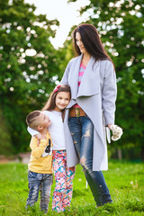 Fototapeta premium Mother with daughter and son in the meadow