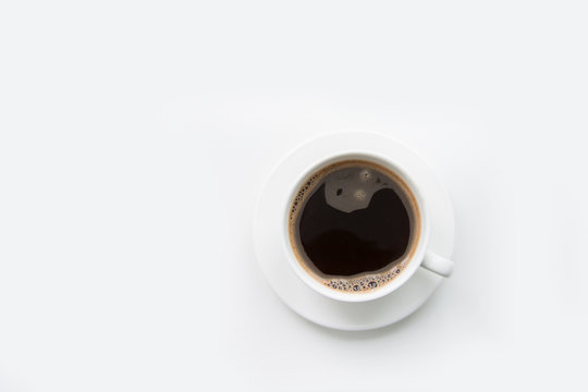 Christmas And Winter Concept. White Mug Of Hot Black Coffee On White Background. Top View.