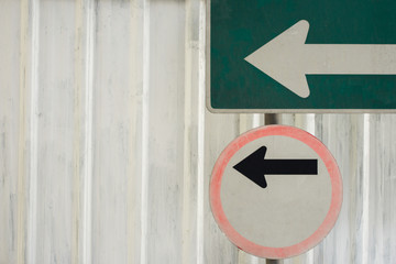 two left sign in fornt of white galvanized sheet