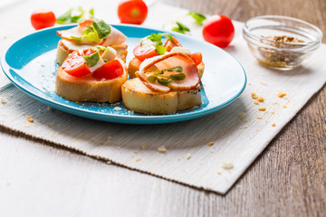 Bruschetta with tomato, cheese and bacon