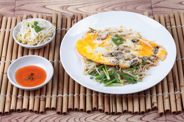 Oyster omelet with herb call Hoi Tod Khai in Thai .