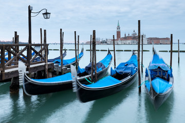 Fototapeta na wymiar View across the Grand Canal in Venice with three Gondolas in the foreground.