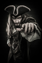 portrait of bearded and hairy pirate pointing into the viewer, shallow DOF