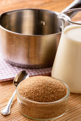 Cooking process of caramel sauce on brown wooden background. Cooking process.