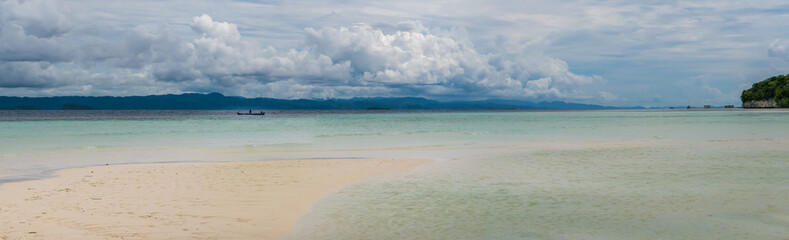 Fototapeta na wymiar Sandy Bank on Kri Island, Low Tide, Gam in Background. Raja Ampat, Indonesia, West Papua