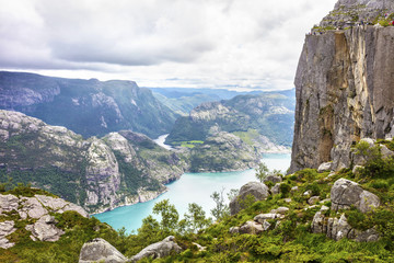 Fototapeta na wymiar Tourists hiking at the Preikestolen cliff in lysefjorden Norway