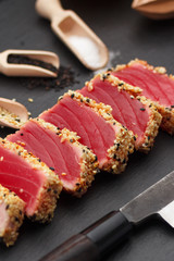 rilled tuna fillet with sesame on a stone plate.