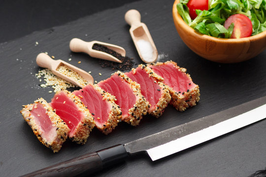 rilled tuna fillet with sesame on a stone plate.