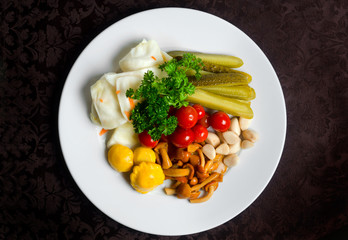 Marinated onion cabbage garlic cucumber cherry tomatoes on a table in a plate