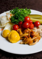 Marinated onion cabbage garlic cucumber cherry tomatoes on a table in a plate