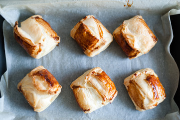 Freshly baked cheese rolls in a pan