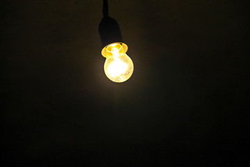 Electric light bulb on dark background