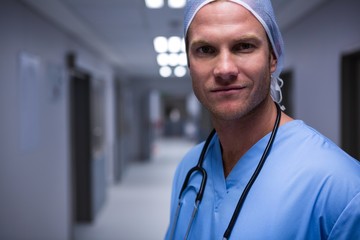 Portrait of surgeon standing in corridor