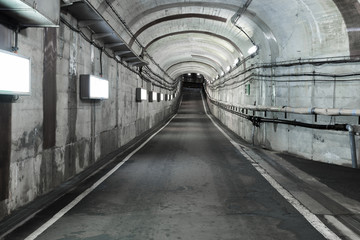 Plakat Long road tunnel with lighting. Empty car in tunnel.