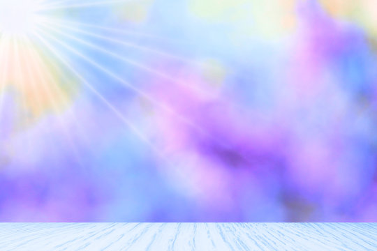 Blurred abstract soft blue and purple pastel background with the sunlight Len flare from the left corner with wood floor