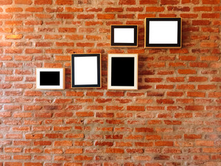 Fototapeta premium Brick wall with photo frames,vintage style.