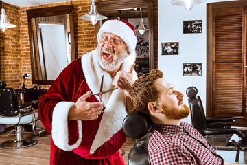 Santa claus as master at barber shop