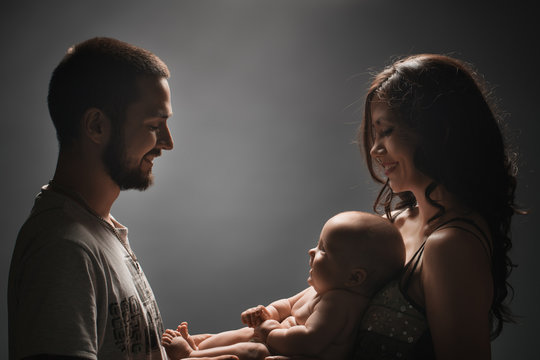 Young family and newborn baby studio shot