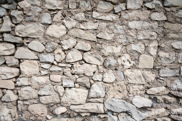 Fototapeta premium Stone wall with mortar and cracking areas