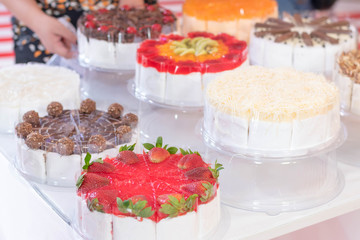 closeup delicious cake with colorful fruit and chocolate with wh