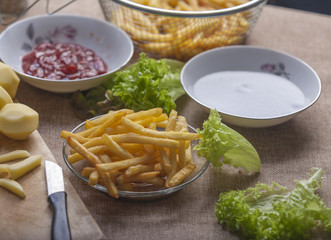 Fresh fried french fries with ketchup on wooden background