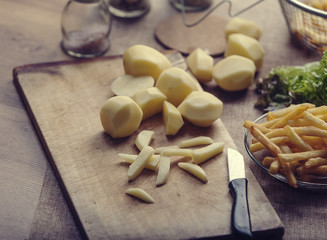 Fresh fried french fries with ketchup on wooden background